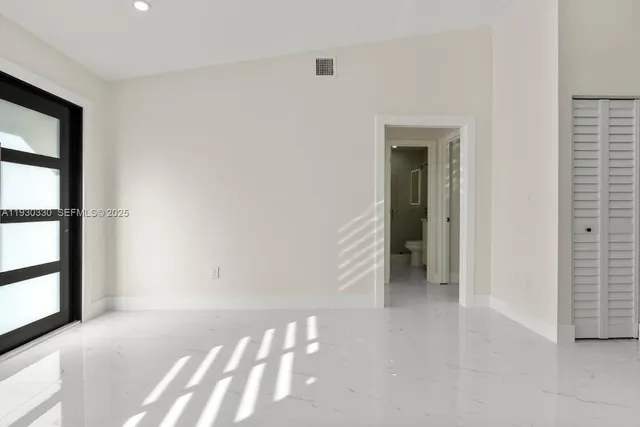 a view of a hallway with wooden floor and entryway