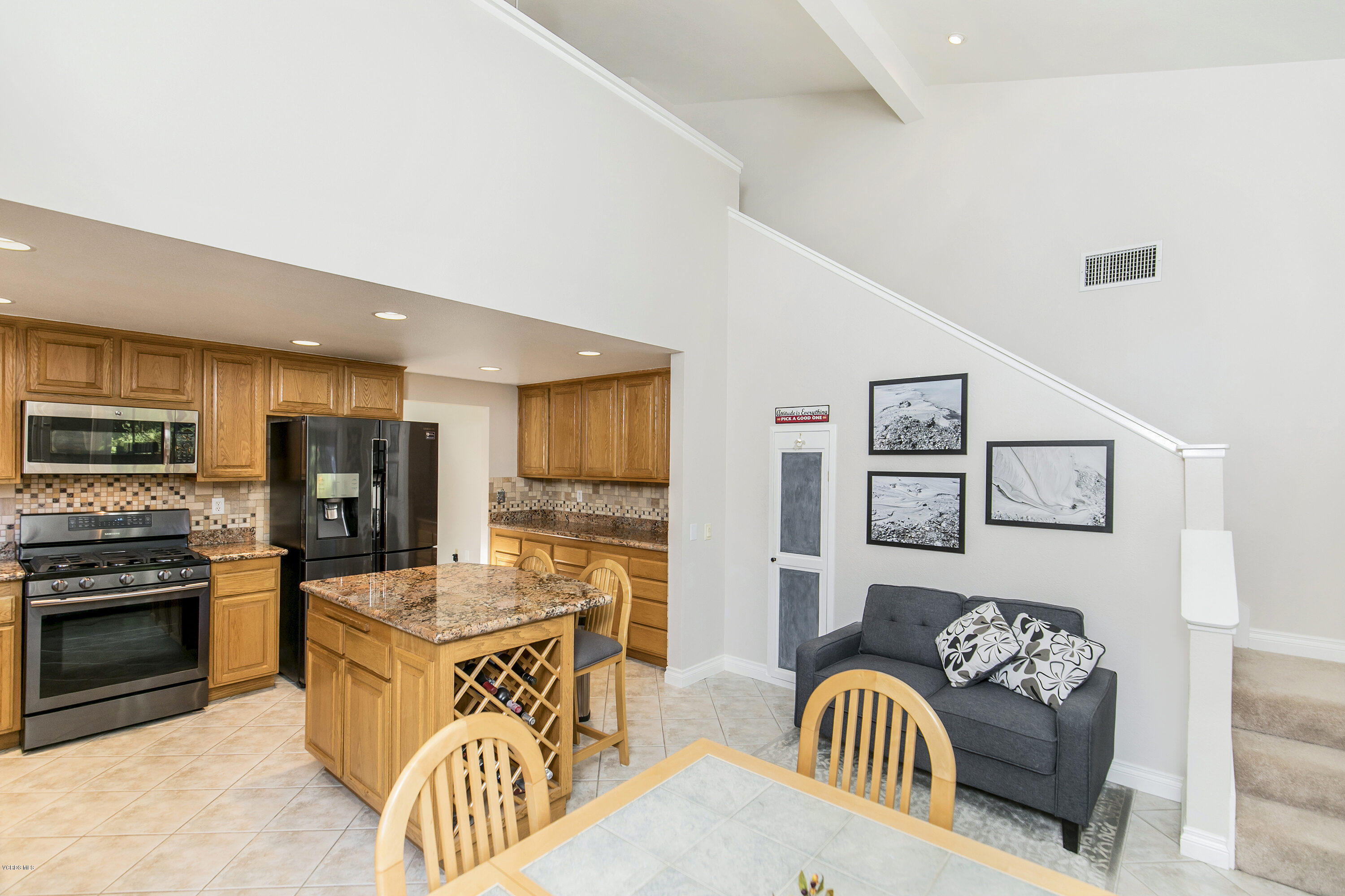 4722 Avedon Road Moorpark, CA 93021 - Photo 13 of 38 a kitchen with stainless steel appliances granite countertop a stove top oven a sink a dining table and chairs