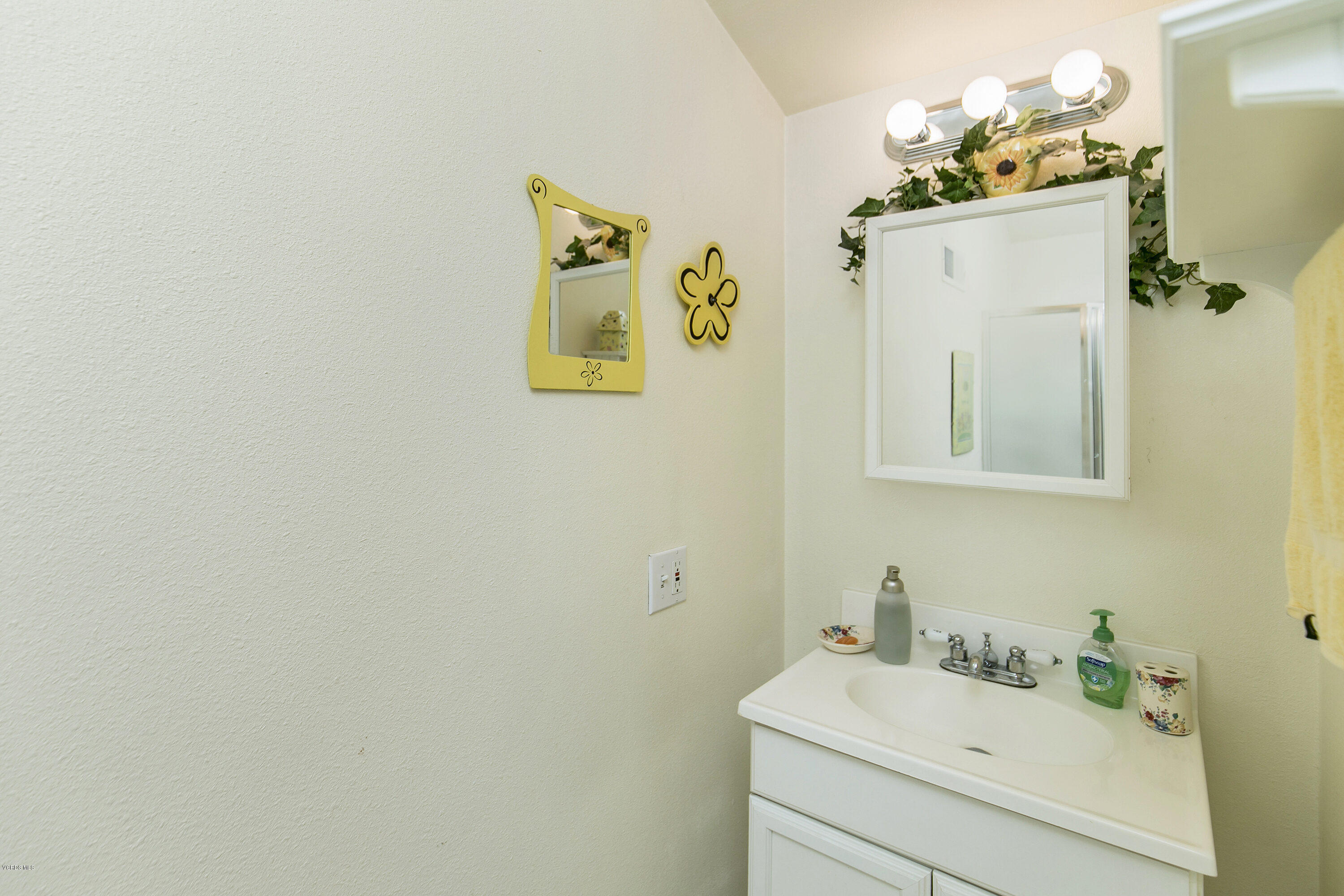4722 Avedon Road Moorpark, CA 93021 - Photo 22 of 38 a bathroom with a sink mirror and vanity