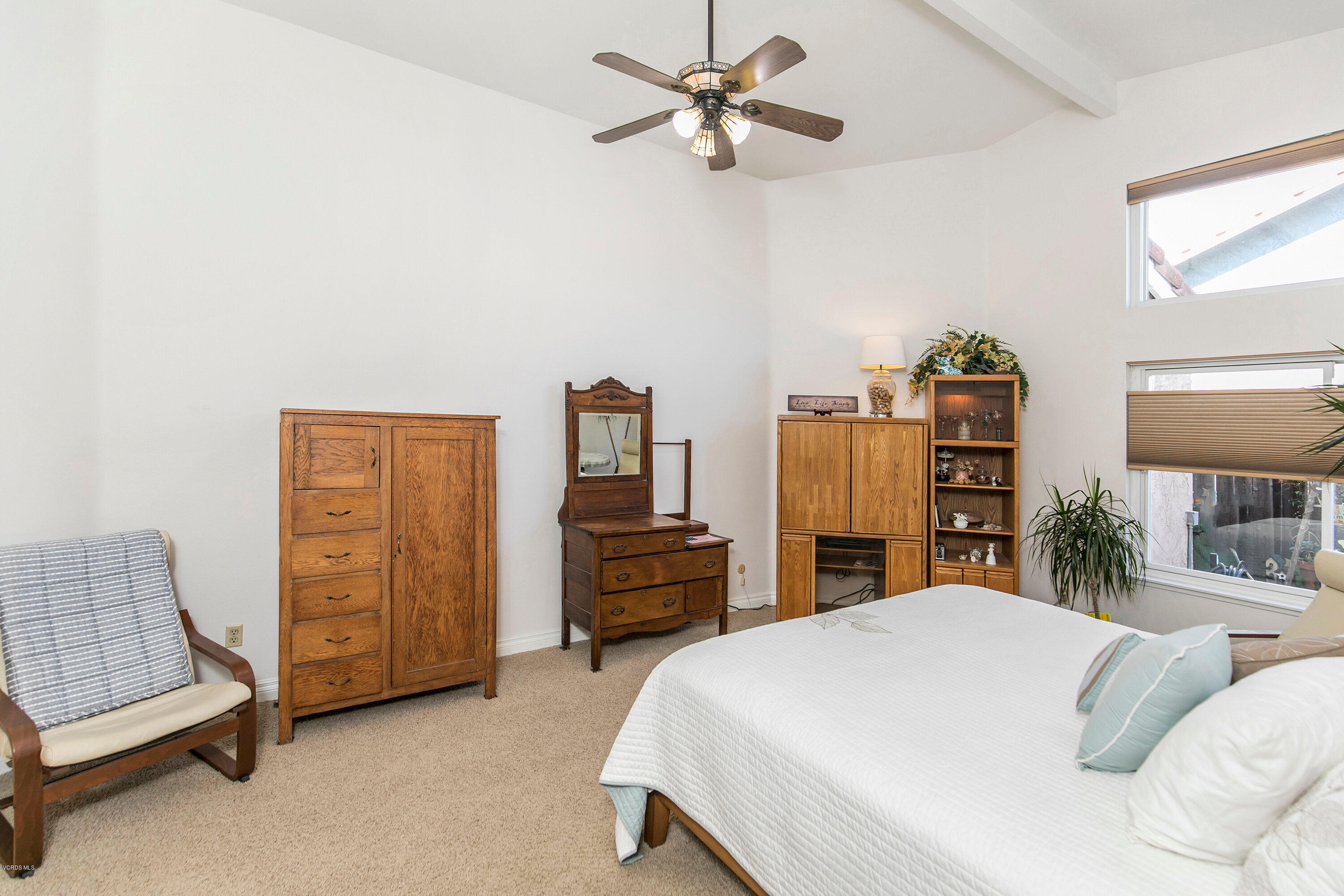 4722 Avedon Road Moorpark, CA 93021 - Photo 23 of 38 a bedroom with a bed and a chandelier