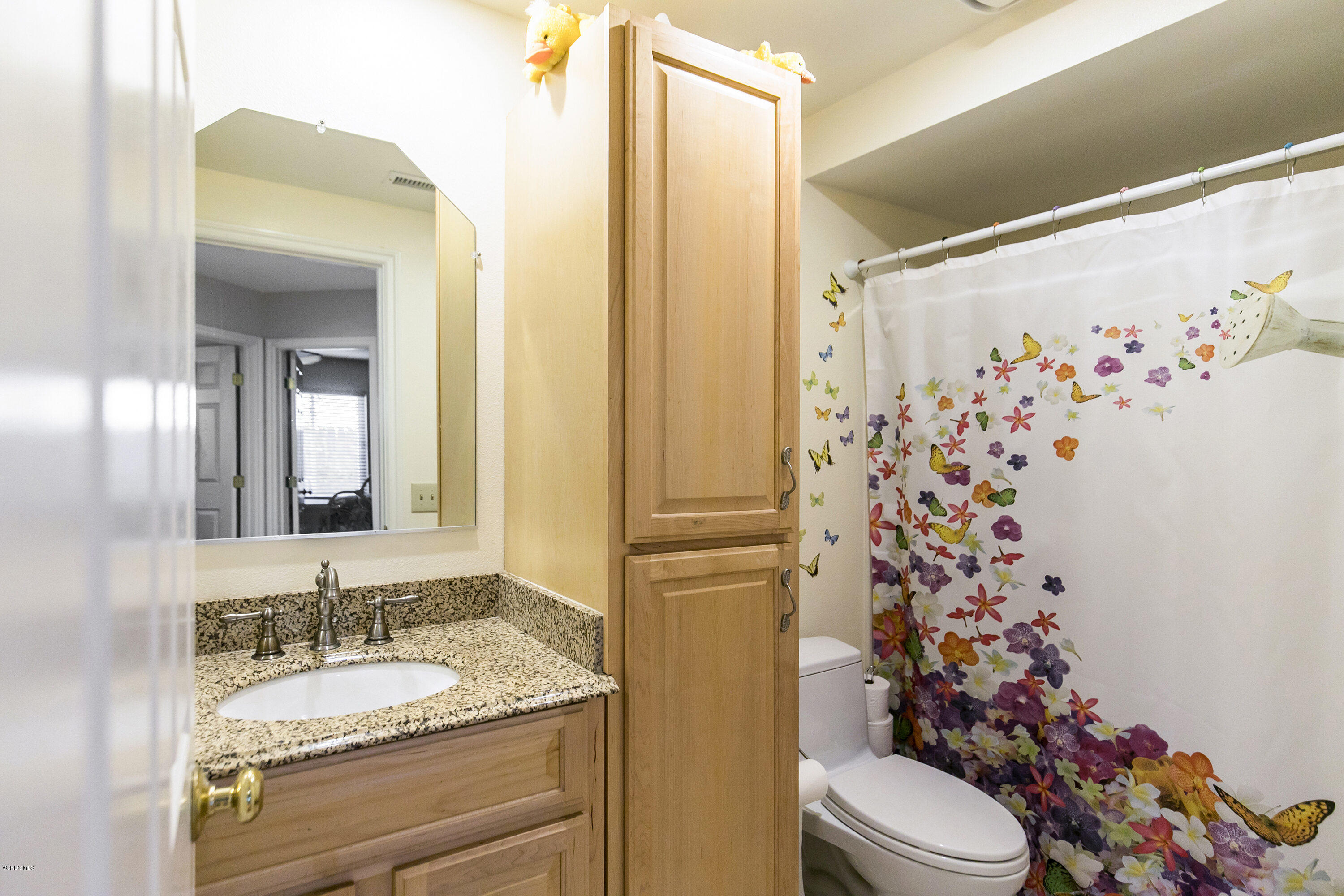 4722 Avedon Road Moorpark, CA 93021 - Photo 30 of 38 a bathroom with a granite countertop sink mirror vanity and toilet