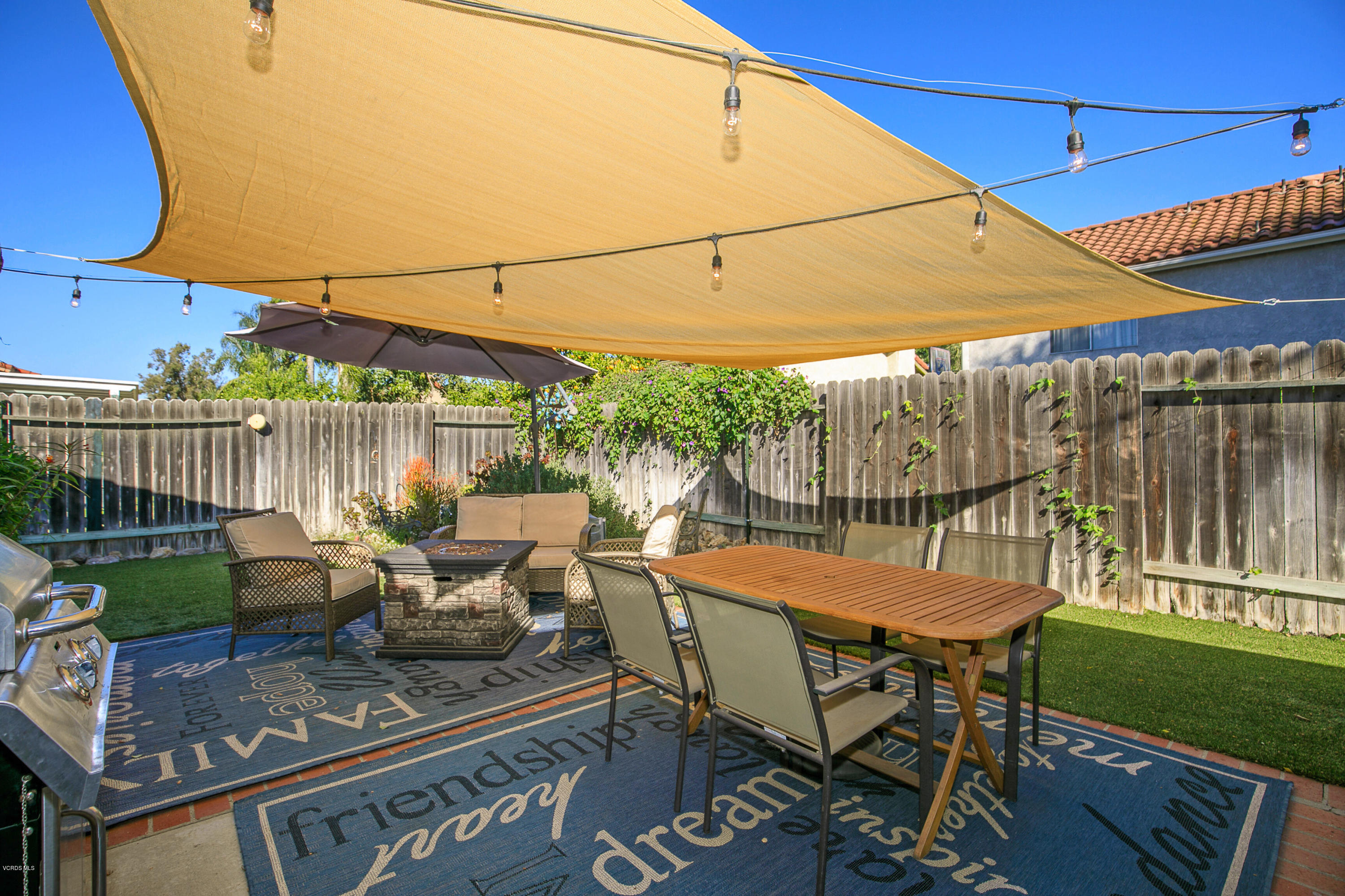 4722 Avedon Road Moorpark, CA 93021 - Photo 33 of 38 a view of a patio with table and chairs under an umbrella