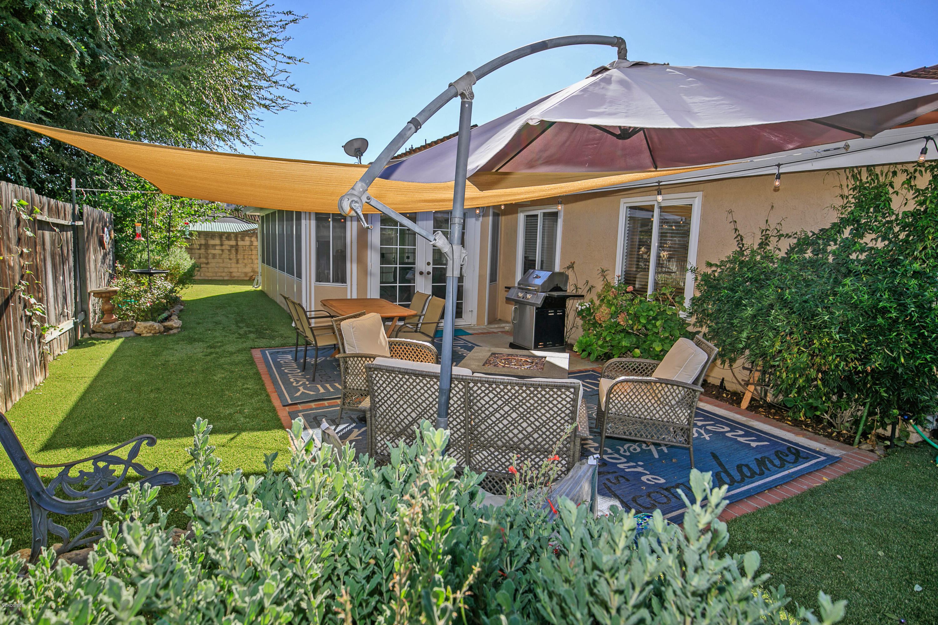 4722 Avedon Road Moorpark, CA 93021 - Photo 35 of 38 a view of a patio with couches table and chairs under an umbrella