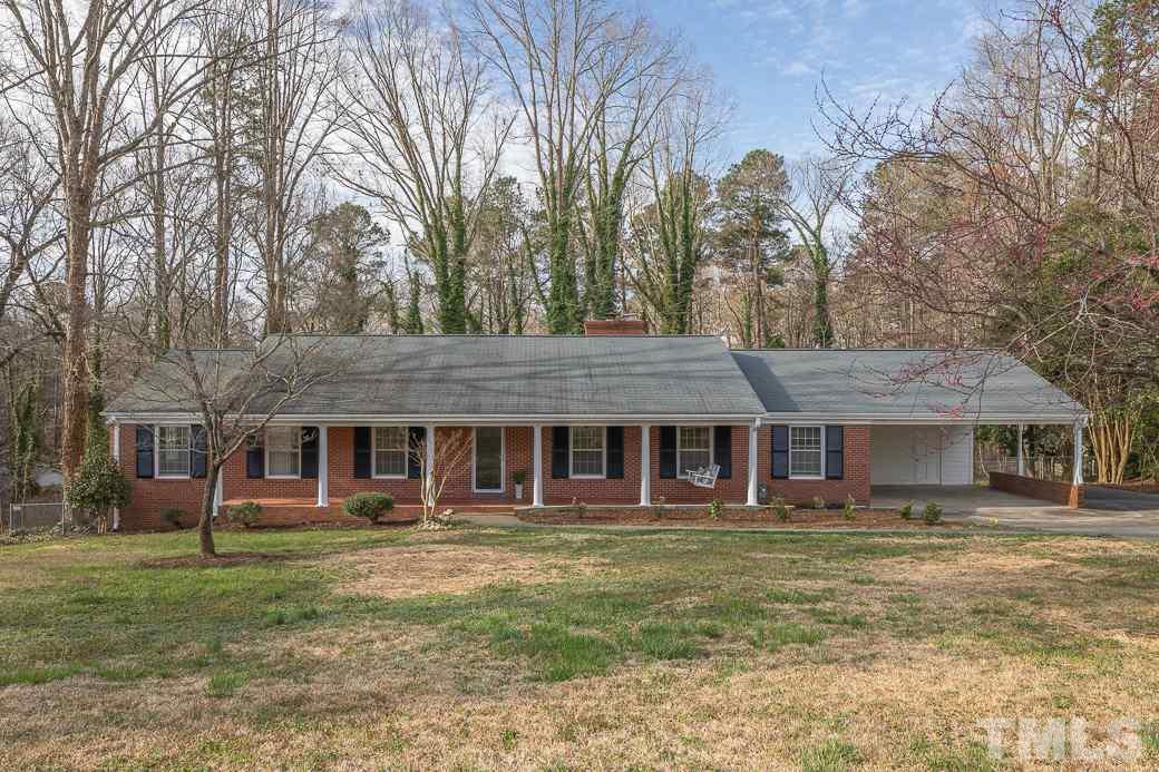 8913 Hunting Trail Raleigh, NC 27613 - Photo 1 of 19 a front view of a building with a yard