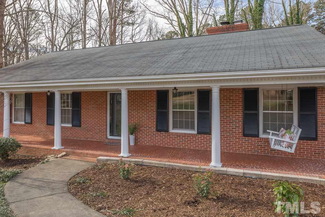 8913 Hunting Trail Raleigh, NC 27613 - Photo 2 of 19 a front view of a house with garden