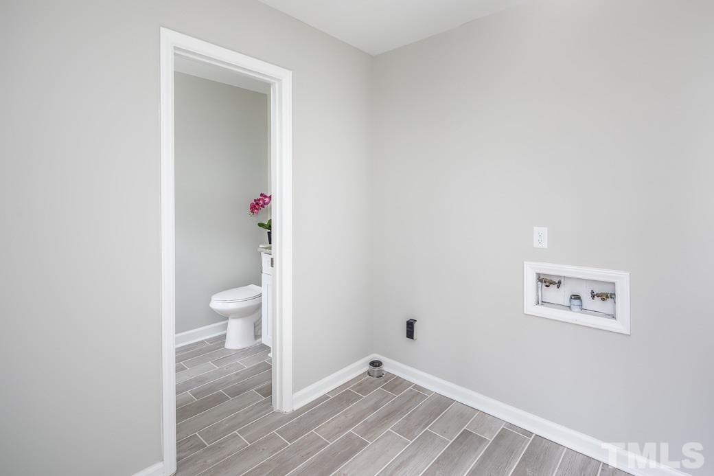 8913 Hunting Trail Raleigh, NC 27613 - Photo 11 of 19 a view of a bathroom with a sink and a toilet