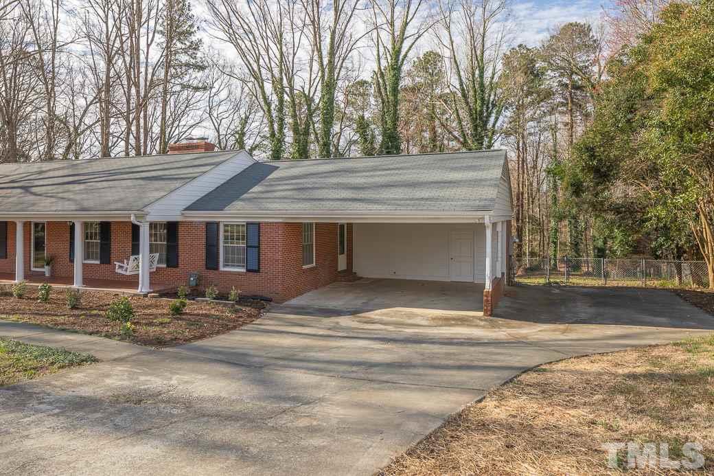 8913 Hunting Trail Raleigh, NC 27613 - Photo 18 of 19 a view of a house with a yard and trees