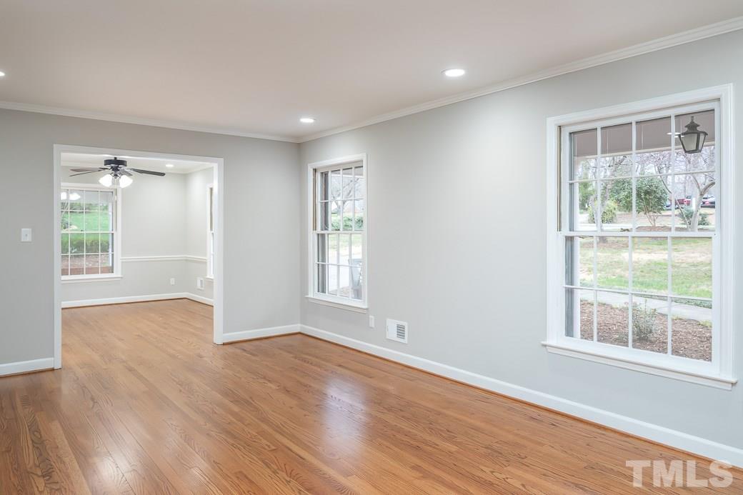 8913 Hunting Trail Raleigh, NC 27613 - Photo 3 of 19 a view of an empty room with wooden floor and a window