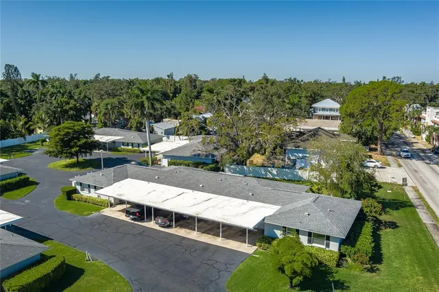 an aerial view of a house with a garden and lake view