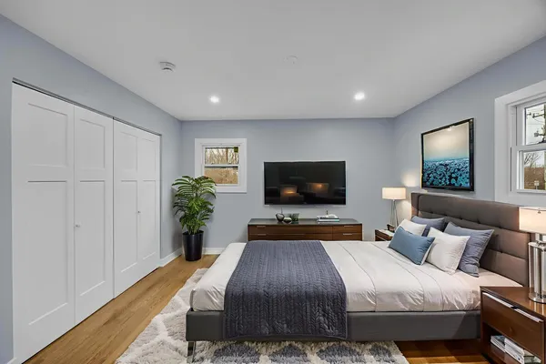 a bedroom with a bed and a flat screen tv