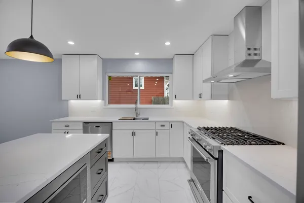 a kitchen with a sink stove and cabinets