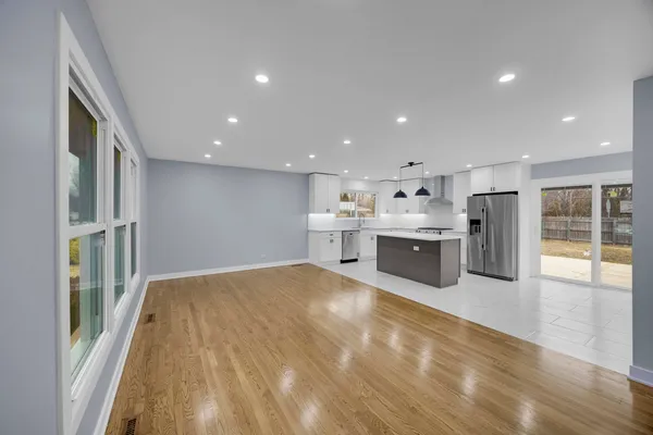 a large white kitchen with stainless steel appliances cabinets
