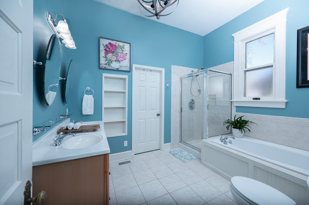 215 7th Street Columbus, GA 31901 - Photo 34 of 64 a en suite bathroom with a granite countertop tub sink and mirror