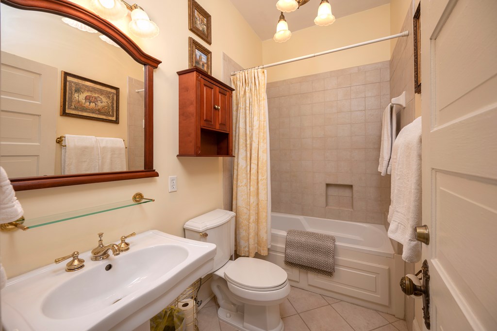 215 7th Street Columbus, GA 31901 - Photo 45 of 64 a bathroom with a sink toilet and shower