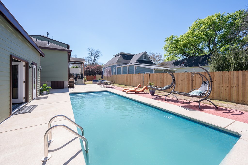 215 7th Street Columbus, GA 31901 - Photo 58 of 64 a view of a swimming pool with a lounge chairs