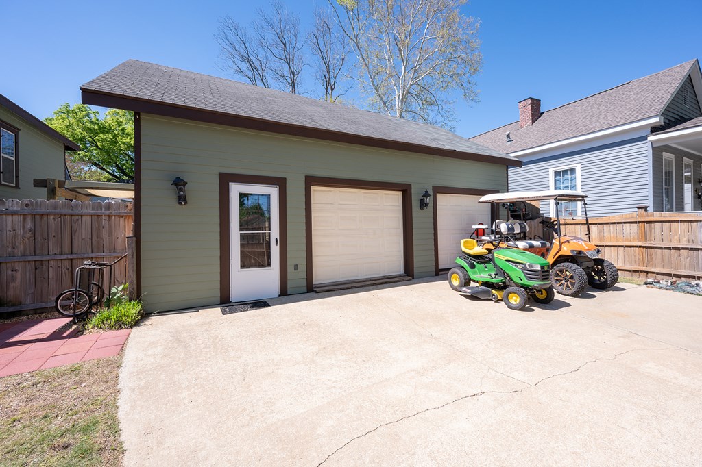 215 7th Street Columbus, GA 31901 - Photo 60 of 64 a front view of a house with a large window and potted plants