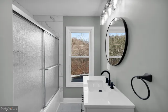 a bathroom with a sink and a mirror
