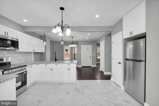 a large kitchen with cabinets and stainless steel appliances