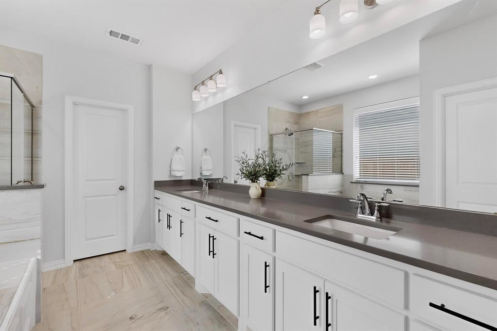 207 Buffalo Boulevard Rhome, TX 76078 - Photo 17 of 40 Dual sinks and wide walkway allow couples to prep or wrap up the day.