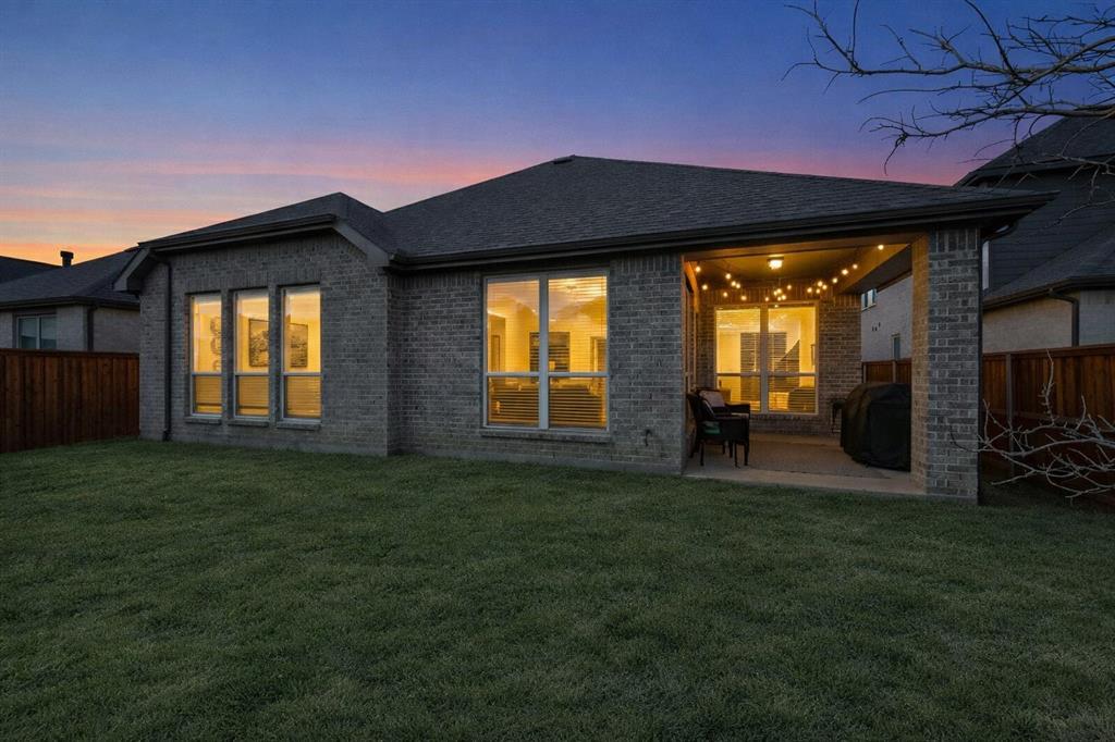 207 Buffalo Boulevard Rhome, TX 76078 - Photo 2 of 40 A tranquil patio glows, signaling calm to end your day.