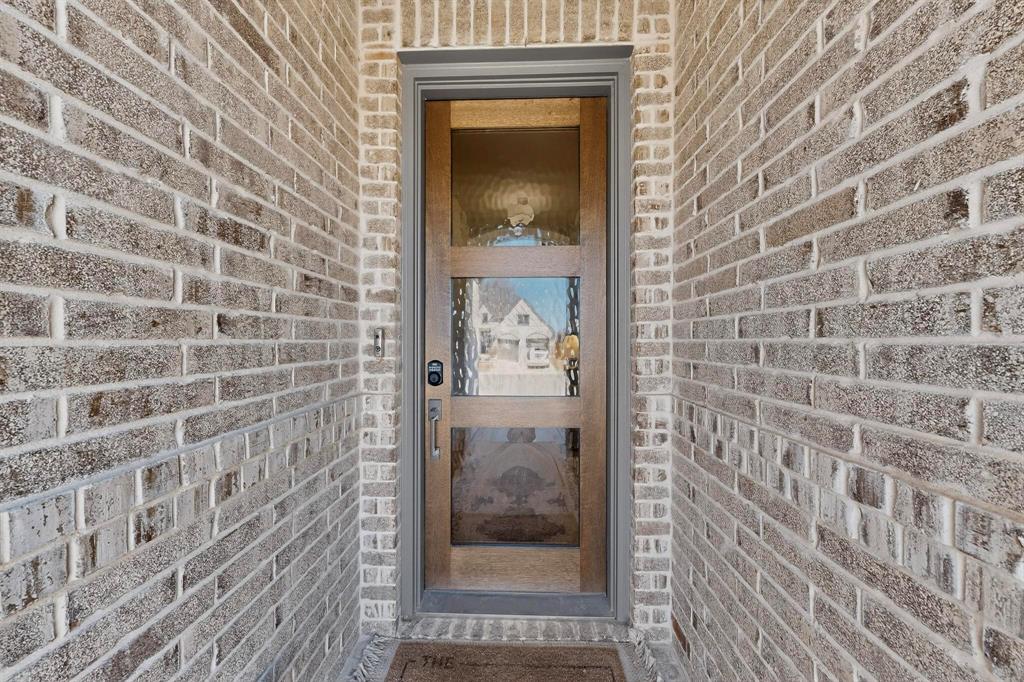 207 Buffalo Boulevard Rhome, TX 76078 - Photo 4 of 40 A modern mahogangy, 3-lite door draws you under the covered front porch.