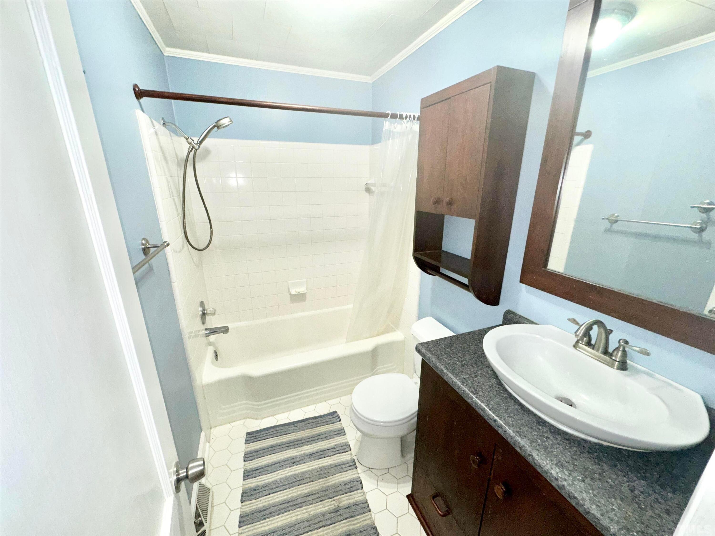 700 Mial Street Raleigh, NC 27608 - Photo 12 of 15 a bathroom with a granite countertop sink toilet and shower a mirror