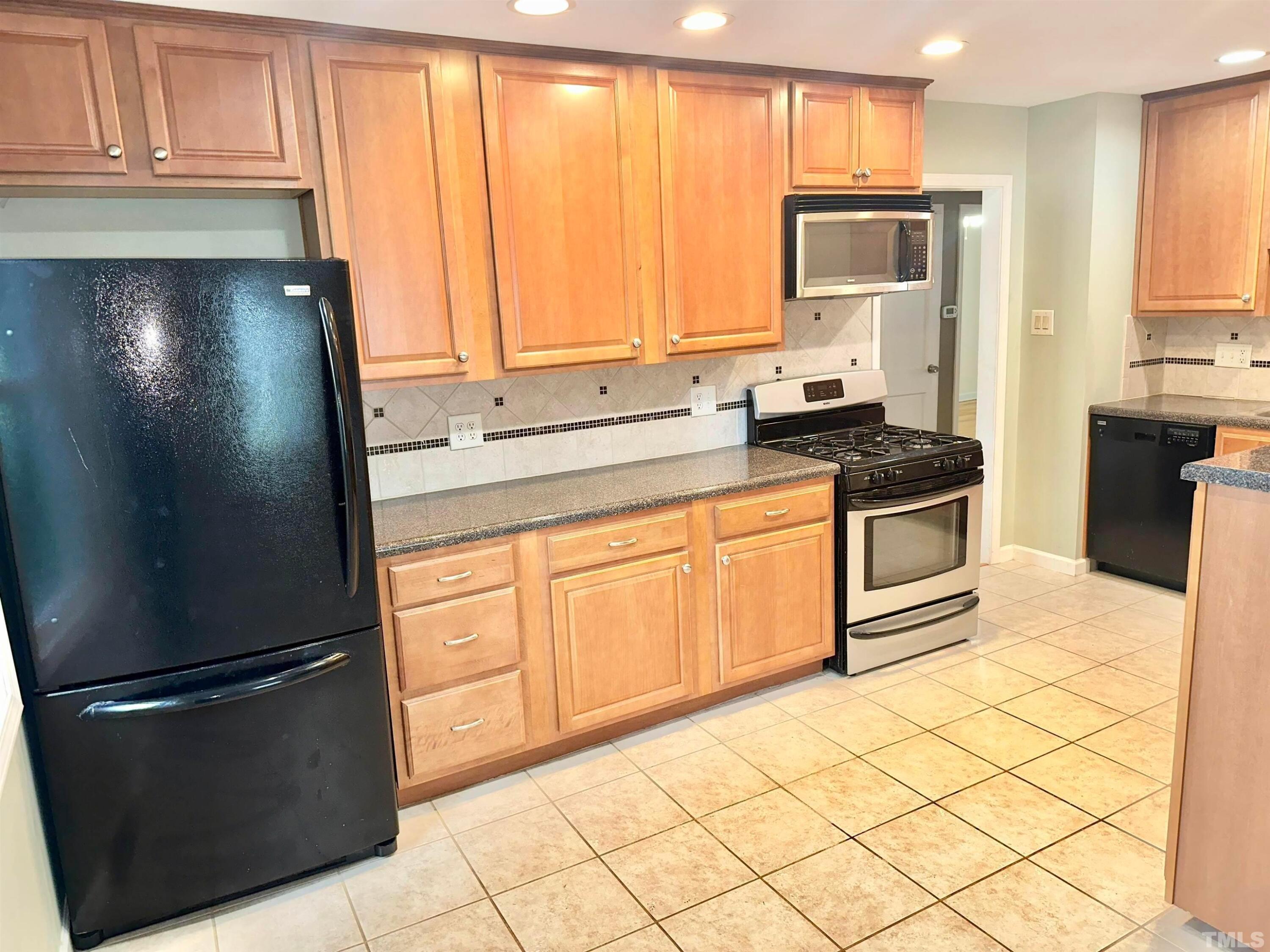 700 Mial Street Raleigh, NC 27608 - Photo 7 of 15 a kitchen with stainless steel appliances granite countertop a refrigerator sink and cabinets