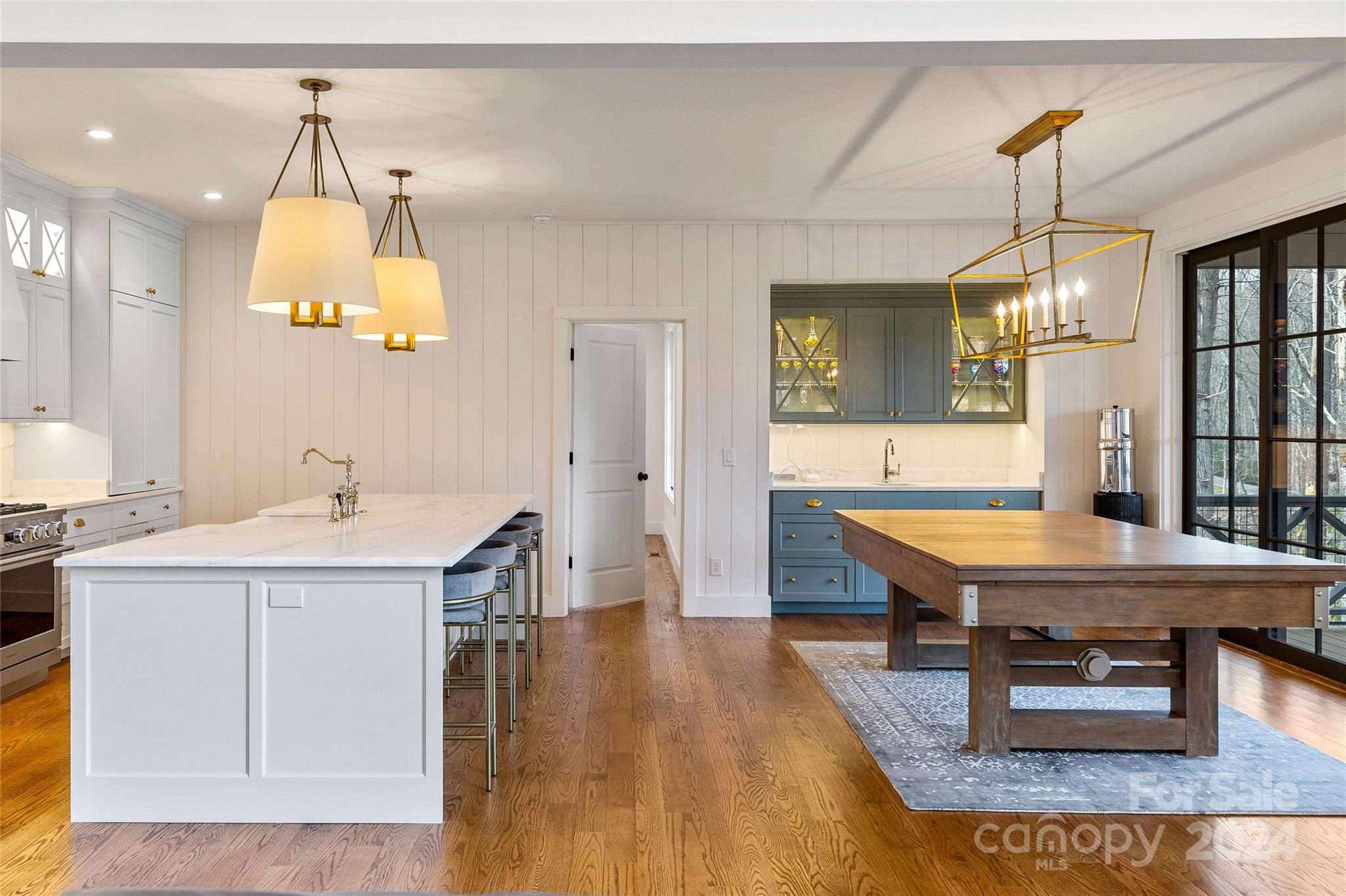 510 Boiling Springs Road Sapphire, NC 28774 - Photo 11 of 48 a room with kitchen island a table and chairs in it