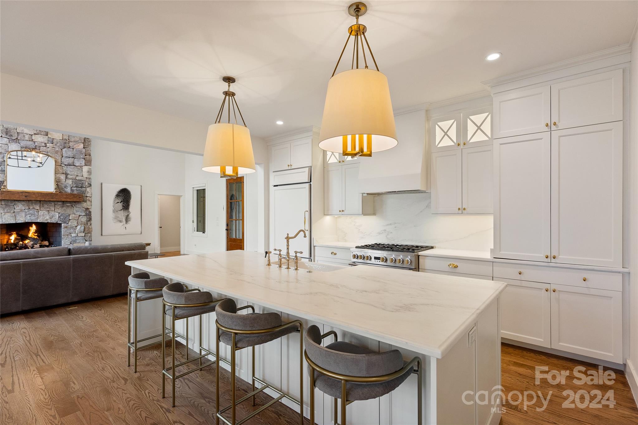 510 Boiling Springs Road Sapphire, NC 28774 - Photo 15 of 48 a kitchen with kitchen island a stove a chandelier a sink a dining table and chairs
