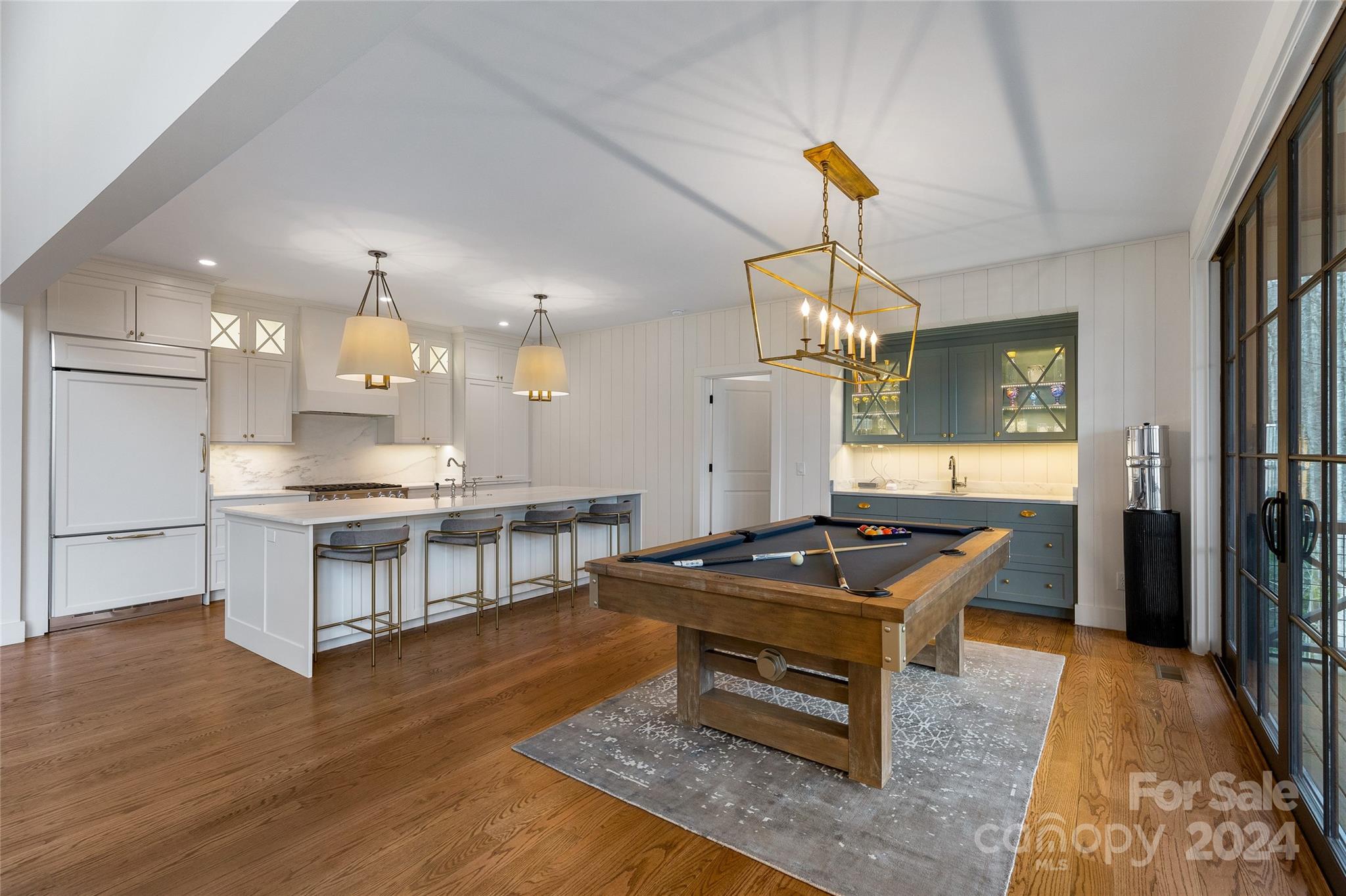 510 Boiling Springs Road Sapphire, NC 28774 - Photo 20 of 48 a kitchen with kitchen island granite countertop a stove oven a sink dishwasher and a dining table with wooden floor