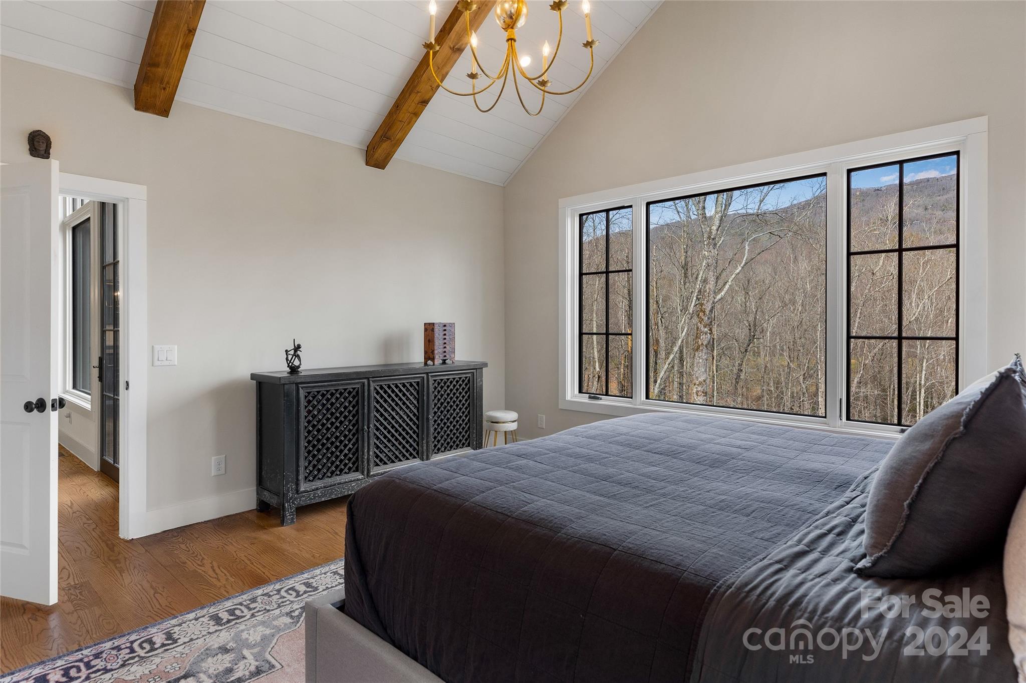 510 Boiling Springs Road Sapphire, NC 28774 - Photo 23 of 48 a bedroom with a bed and a large window