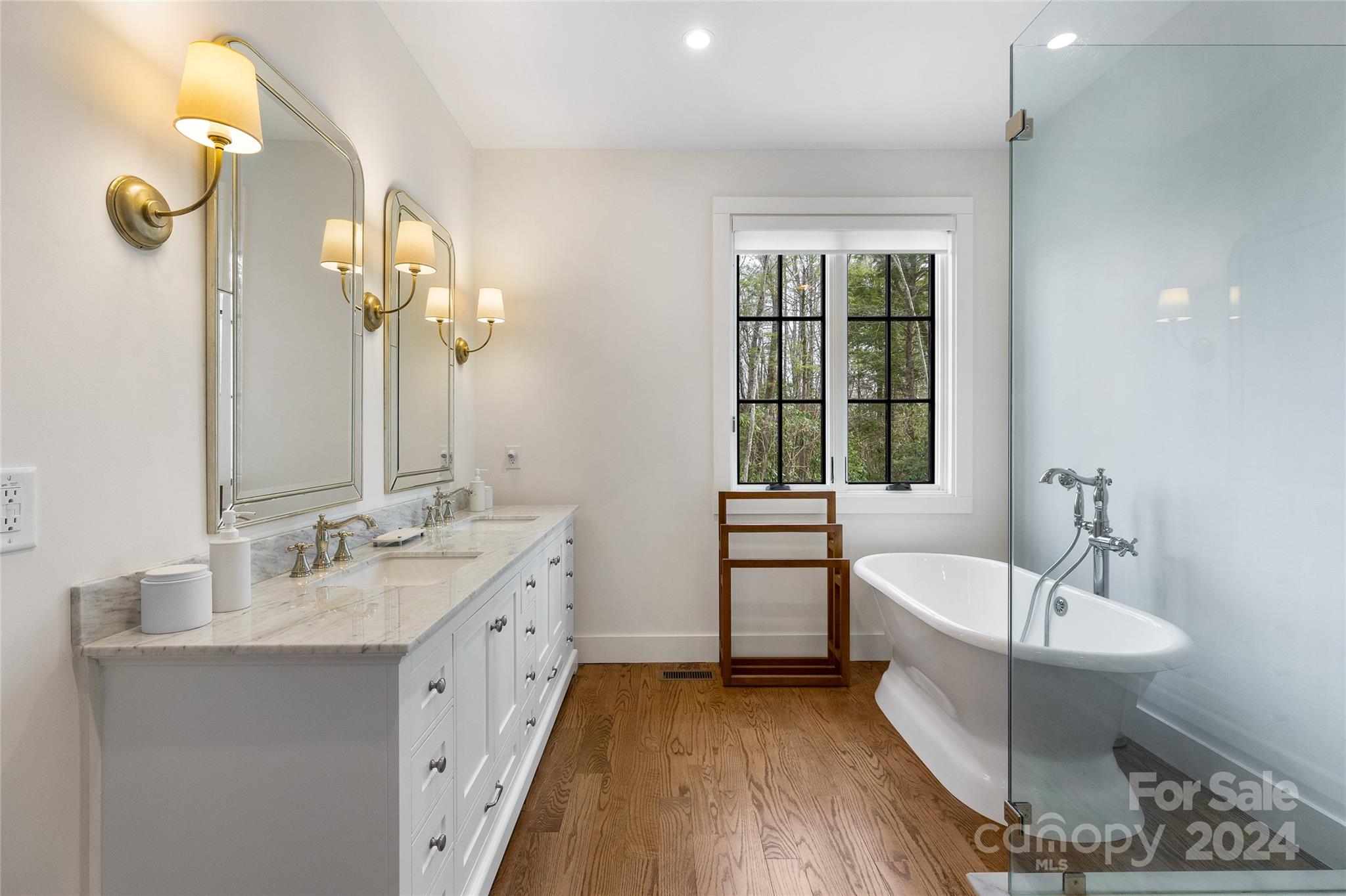 510 Boiling Springs Road Sapphire, NC 28774 - Photo 27 of 48 a spacious bathroom with a double vanity sink mirror and a bathtub