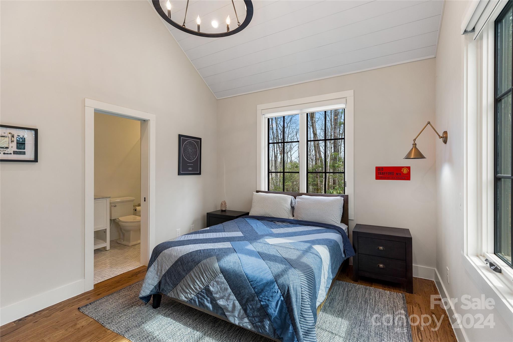 510 Boiling Springs Road Sapphire, NC 28774 - Photo 30 of 48 a bedroom with a bed and wooden floor