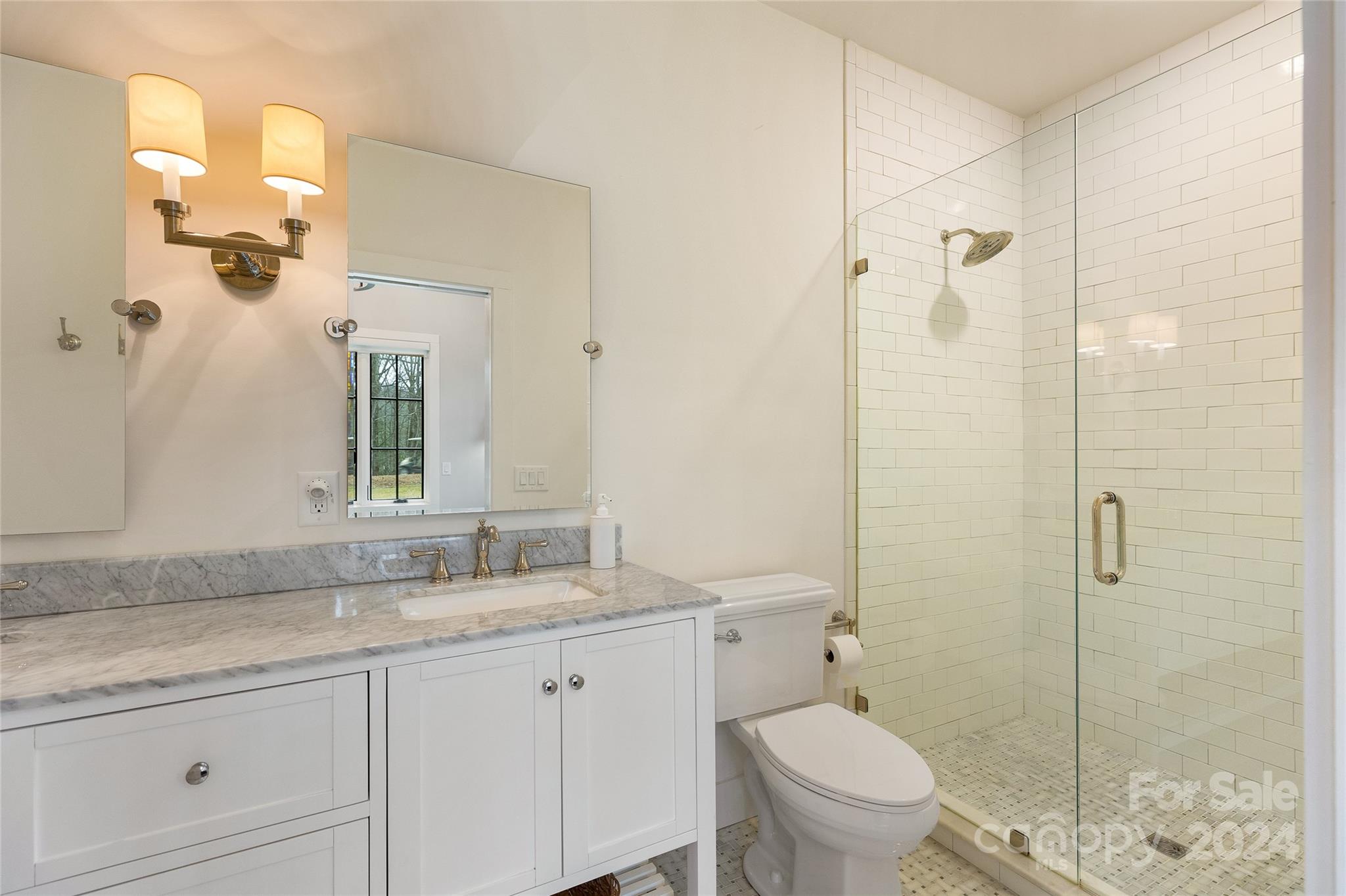 510 Boiling Springs Road Sapphire, NC 28774 - Photo 31 of 48 a bathroom with a granite countertop sink a toilet and a mirror