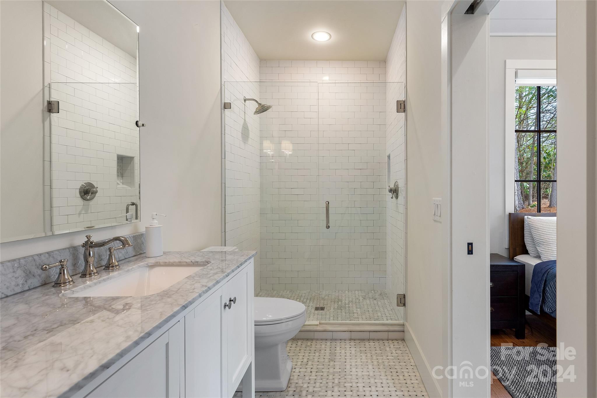 510 Boiling Springs Road Sapphire, NC 28774 - Photo 33 of 48 a bathroom with a granite countertop sink a toilet and shower