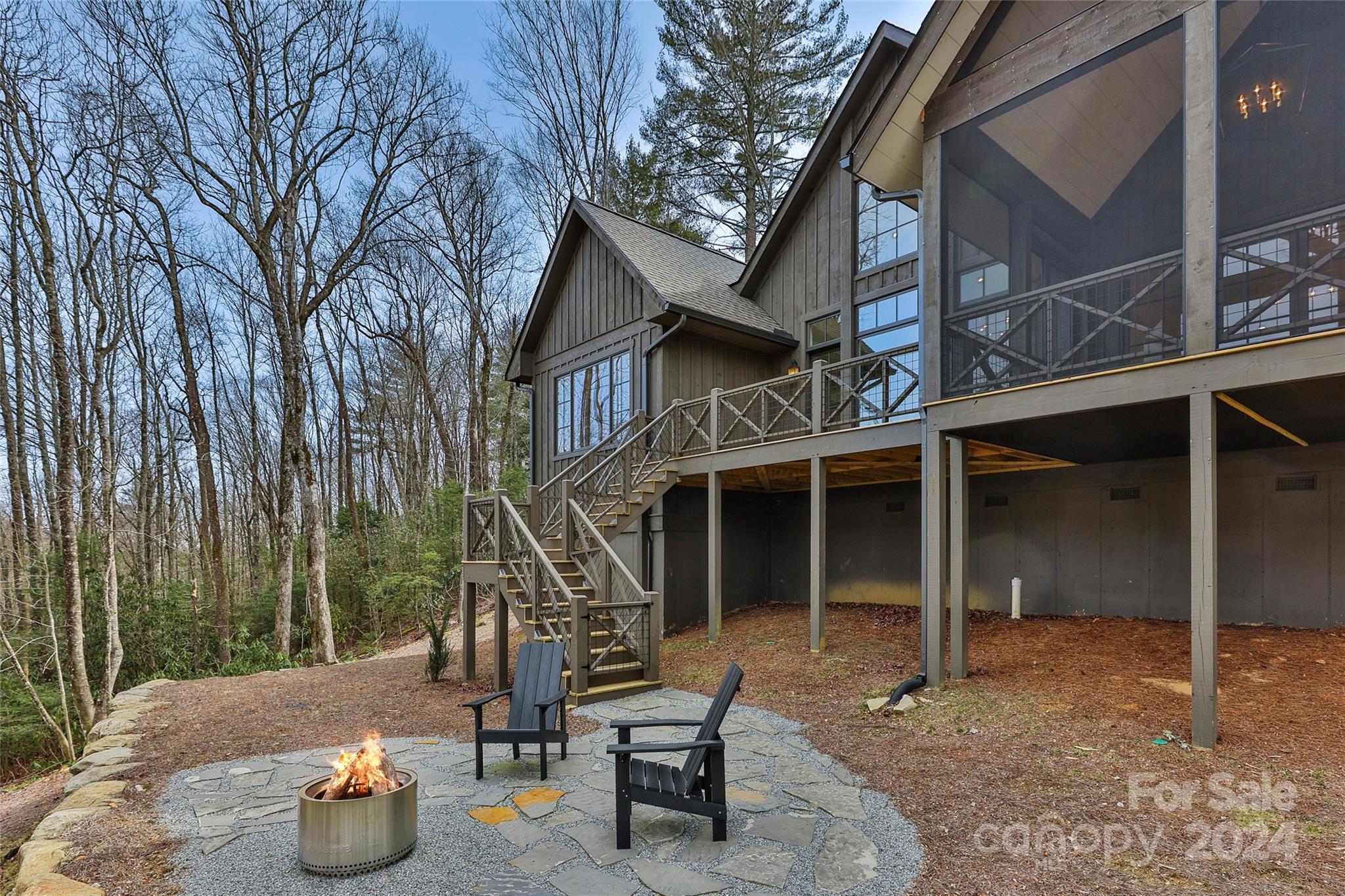 510 Boiling Springs Road Sapphire, NC 28774 - Photo 45 of 48 a view of a chair and fire pit in backyard of the house