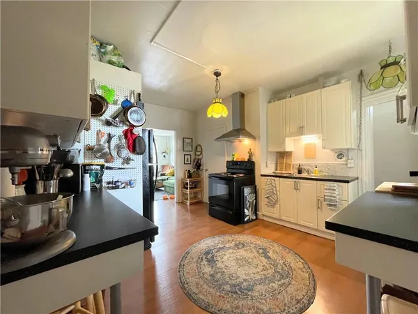 a kitchen filled with stainless steel appliances granite countertop a sink counter space and refrigerator
