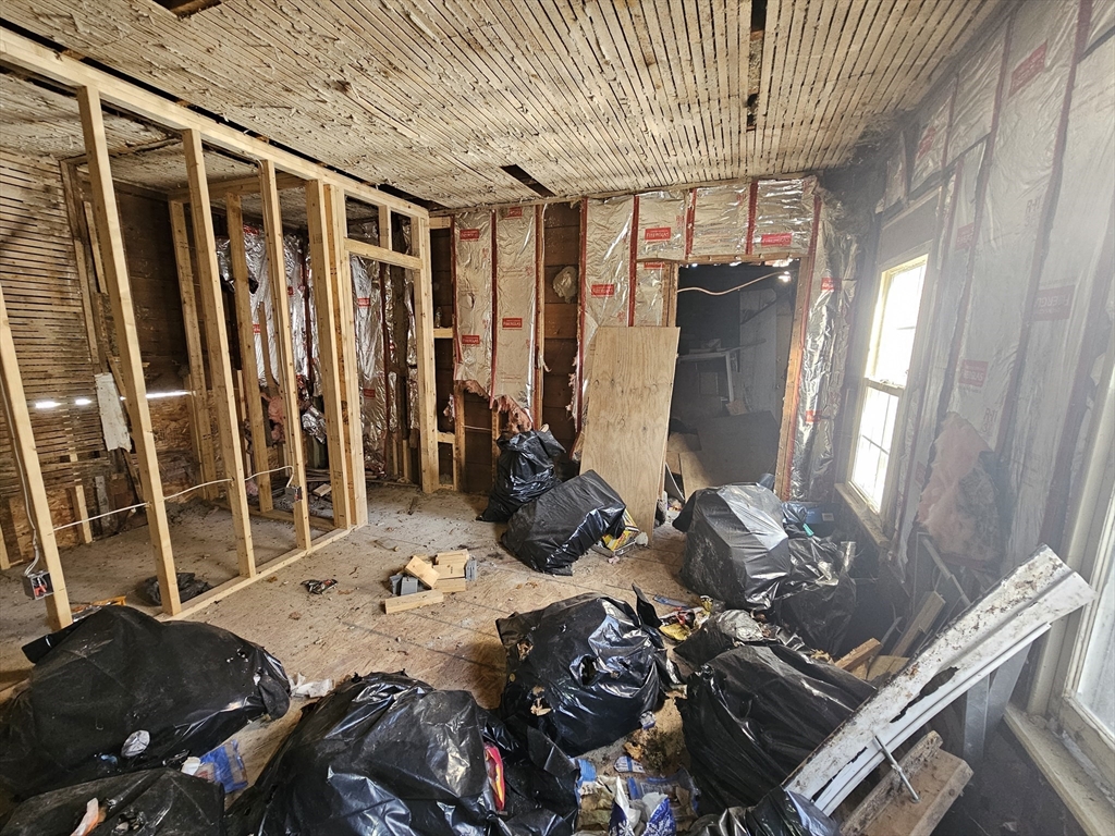 27 Hall Street North Adams, MA 01247 - Photo 14 of 32 a bed sitting in a bedroom next to a window