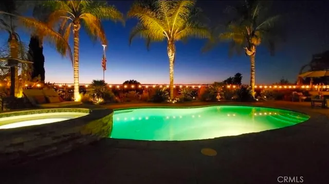 a view of an swimming pool with an outdoor space and seating area