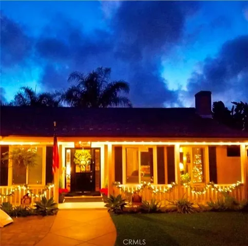 a front view of a house with a garden and yard