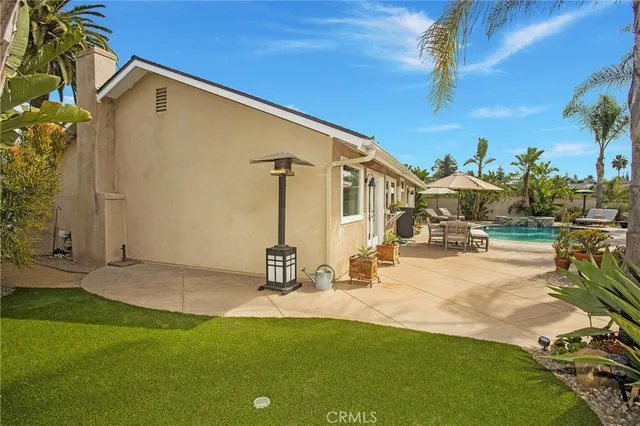 a view of a house with swimming pool and sitting area