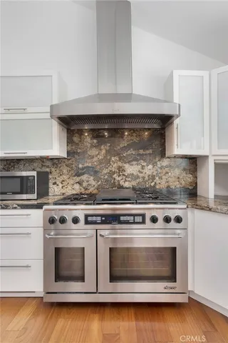 a stove top oven sitting inside of a kitchen