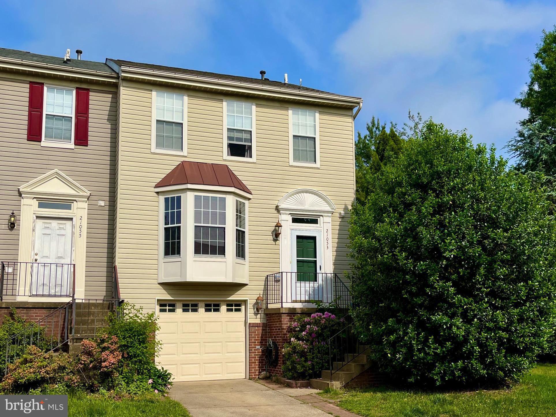21053 Cornerpost Square Ashburn, VA 20147 - Photo 1 of 9 a front view of a house with a yard