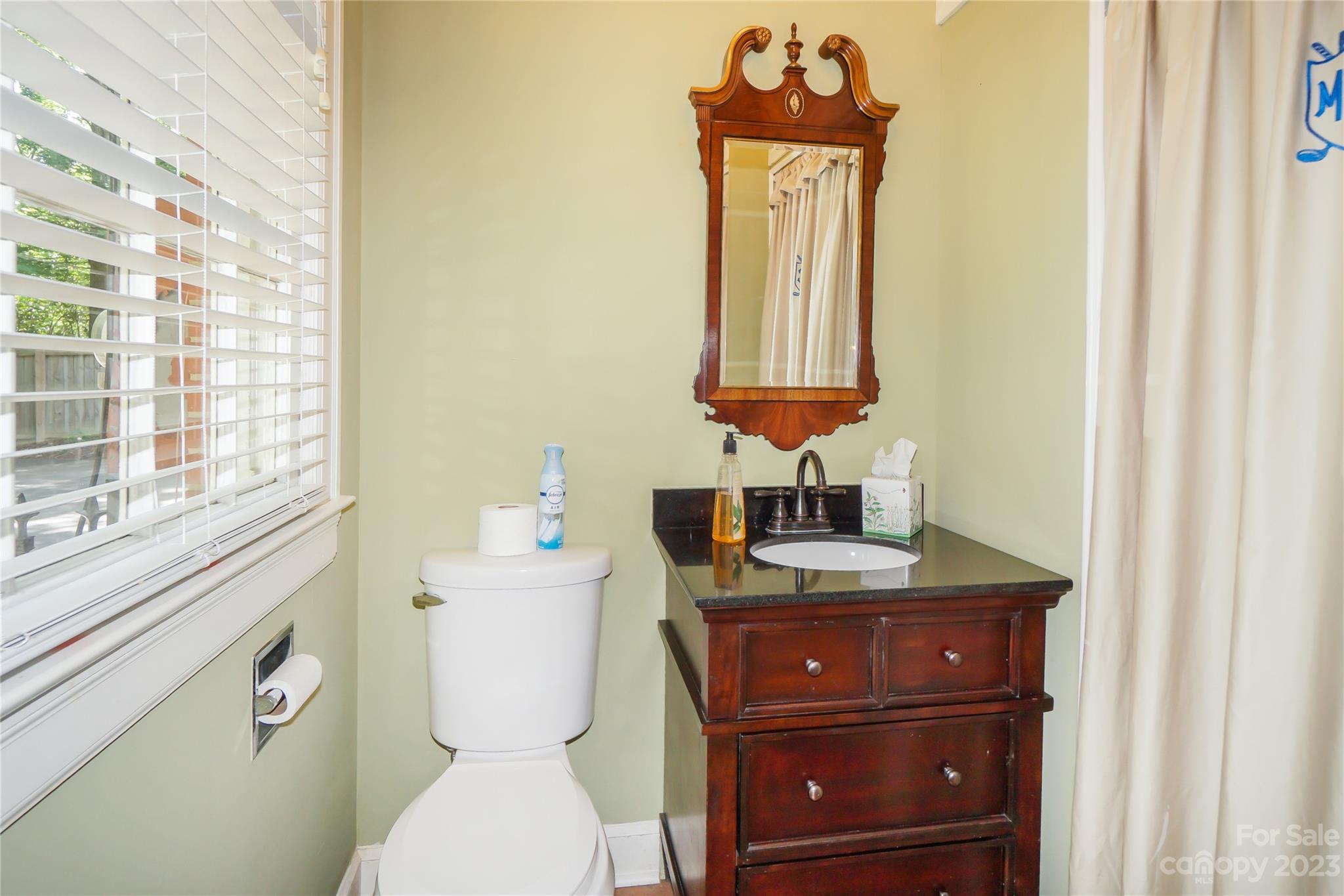620 North 9th Street, Unit 5/6 Albemarle, NC 28001 - Photo 31 of 48 a bathroom with a toilet sink and mirror