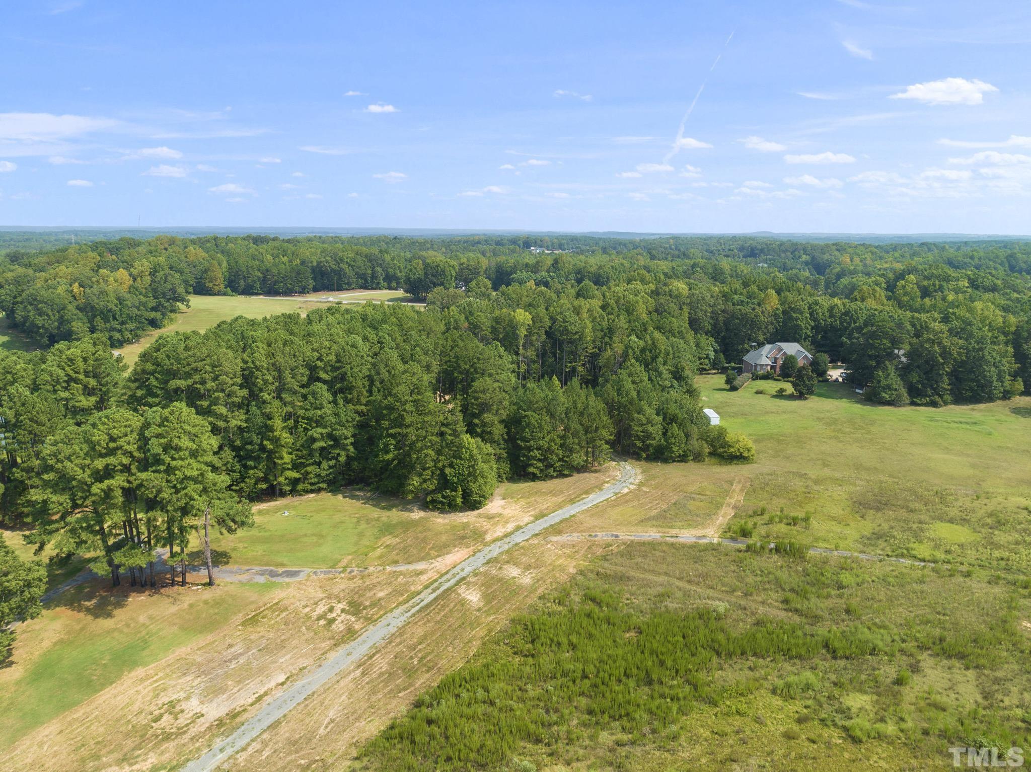 Lot D Chub Lake Road Roxboro, NC 27574 - Photo 21 of 29 a view of a field with grass and a building in background