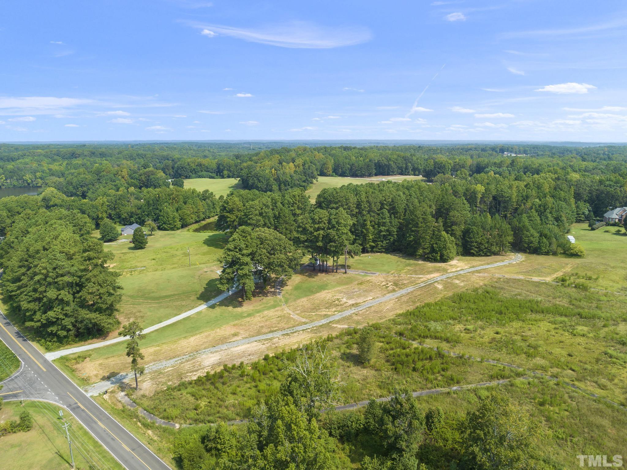 Lot D Chub Lake Road Roxboro, NC 27574 - Photo 5 of 29 a view of a big yard with table and chairs under an umbrella
