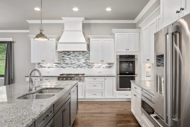 a kitchen with a sink stove and refrigerator