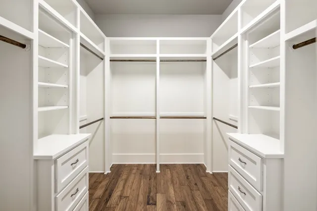 a view of walk in closet with empty racks