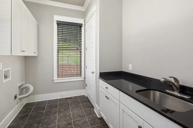 a kitchen with granite countertop a sink and a stove