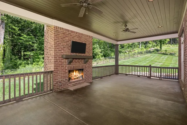 a view of a porch with furniture and garden
